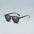 Black sunglasses with dark lenses on a light gray background