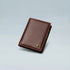 Brown leather wallet on a light gray background