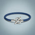 Blue braided bracelet with a silver clasp on a light gray background