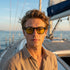 Man wearing sunglasses on a boat with ocean view